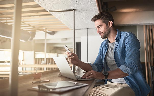 A young business entrepreneur working in a open office